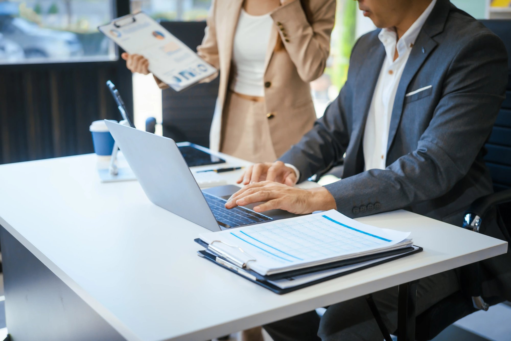 a-businessman-and-woman-sit-at-a-modern-office-tab-2025-04-26-00-05-52-utc